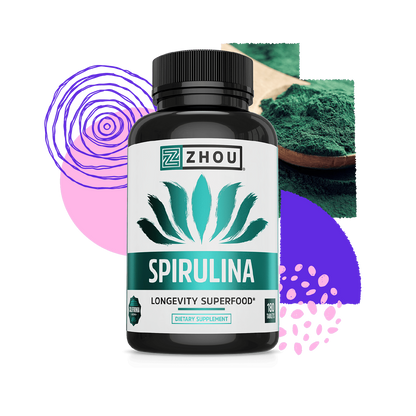 A bottle of Zhou Nutrition Spirulina Tablets sits among abstract shapes and a spoon filled with green spirulina powder.
