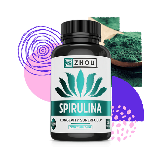 A bottle of Zhou Nutrition Spirulina Tablets sits among abstract shapes and a spoon filled with green spirulina powder.